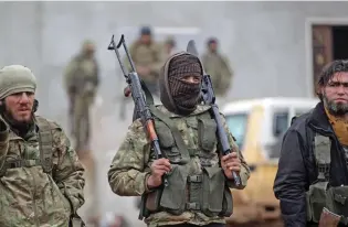  ?? - Reuters ?? END GAME: A rebel fighter carries his weapons on the outskirts of the northern Syrian town of Al Bab, Syria, on Sunday.