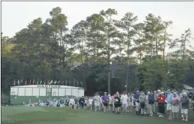  ?? CHARLIE RIEDEL — THE ASSOCIATED PRESS ?? Fans walk along the first hole during the first round of the 2019Master­s in Augusta, Ga.