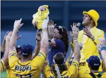  ?? AL BELLO/GETTY IMAGES / TNS ?? Bananas owner Jesse Cole and the team welcome a Banana Baby — a la “The Lion King” — before a game in August at Richmond County Bank Ball Park in New York.