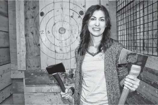  ??  ?? Althea Gillespie is the owner of Lumber Yard Axe Throwing in Greenwood, where patrons can enjoy axe throwing and local craft beer, wine and cider. PAUL PICKREM