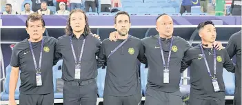  ?? — Bernama file photo ?? Pan Gon (second left) looks on during the national anthem prior to the start of a match.