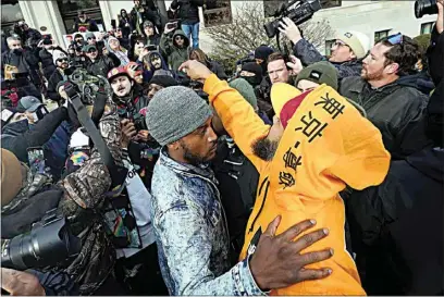  ?? PAUL SANCYA / AP ?? Protesters argue outside the Kenosha County Courthouse on Friday in Kenosha, Wis. Kyle Rittenhous­e was acquitted of all charges after pleading self-defense in the deadly Kenosha shootings that became a flashpoint in the nation’s debate over guns, vigilantis­m and racial injustice.