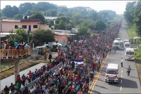  ?? AP PHOTO BYMOISES CASTILLO ?? Central American migrants walking to the U.S. start their day departing Ciudad Hidalgo, Mexico, Sunday, Oct. 21. Despite Mexican efforts to stop them at the border, about 5,000 Central American migrants resumed their advance toward the U.S. border early Sunday in southern Mexico.