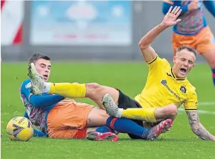  ?? ?? Queen’s Park’s Jack Thomson (left) tackles Dumbarton’s Ross Maclean