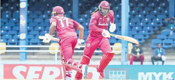  ??  ?? West Indies opening batsmen Evin Lewis (left) and Chris Gayle run between the wickets during the second One-Day Internatio­nal cricket match against India in Port of Spain, Trinidad, yesterday. India won by 59 runs as Lewis top-scored for the West Indies with 65 runs.