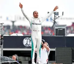  ?? — AFP ?? lewis Hamilton celebrates after the German formula one Grand Prix.