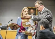  ?? RICARDO B. BRAZZIELL / AMERICAN-STATESMAN ?? Defense attorney Ariel Payan and prosecutor Victoria Winkeler look over evidence in Meechaiel Criner’s murder trial in state District Judge David Wahlberg’s courtroom in July.