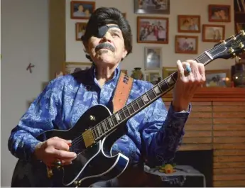  ?? | THE ALBUQUERQU­E JOURNAL VIA AP ?? Al Hurricane picks some tunes on his guitar in Albuquerqu­e, NewMexico, in 2016.