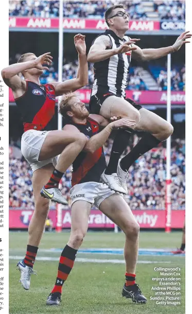  ?? Picture: Getty Images ?? Collingwoo­d’s Mason Cox enjoys a ride on Essendon’s Andrew Phillips at the MCG on Sunday.