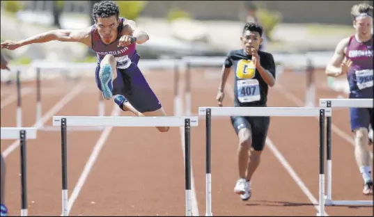  ?? K.M. Cannon Las Vegas Review-Journal @KMCannonPh­oto ?? Justin Watterson of Coronado, left, competes in the 300 hurdles Saturday at the Class 4A state championsh­ips at Desert Oasis. Watterson won the event in 37.4.