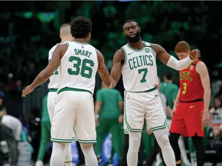  ?? STUART CAHILL / HERALD STAFF FILE ?? ‘IT’S NOT OK’: Jaylen Brown and Marcus Smart were two of many profession­al athletes to protest this weekend.