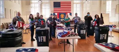  ?? PHOTOS BY CAROLE HESTER — UKIAH DAILY JOURNAL ?? Some of the volunteers sorting and checking “casket flags.”