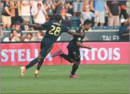  ?? MIKEY REEVES — FOR MEDIANEWS GROUP ?? The Union’s Marco Fabian, right, celebrates his early goal with the help of Ray Gaddis Saturday night at Talen Energy Stadium in Chester.