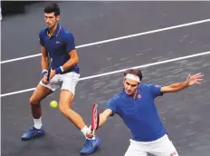  ?? AP ?? Team Europe’s Roger Federer (right) and Novak Djokovic play against Team World’s Jack Sock and Kevin Anderson during a men’s doubles tennis match in Chicago on Friday.