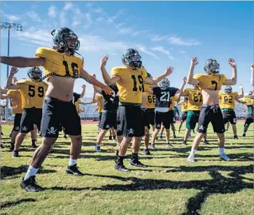  ?? Photograph­s by Marcus Yam Los Angeles Times ?? THE ROCKPORT-FULTON High School football team practices for its game last week. After Hurricane Harvey hammered the campus, players were still finding broken glass and shards of wood in the grass.