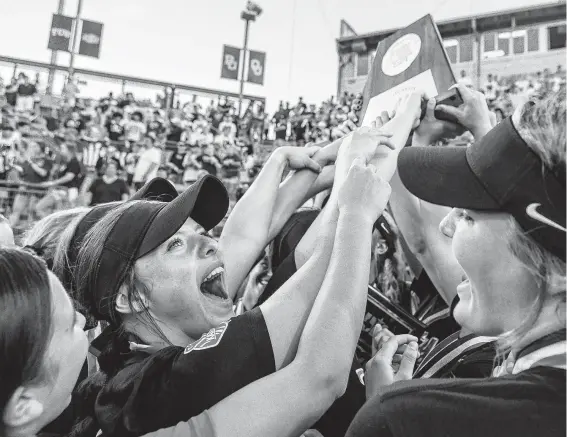  ?? Stephen Spillman / Contrbutor ?? Katy players cannot wait to get their hands on the Class 6A state softball championsh­ip trophy at McCombs Field in Austin on Saturday night.