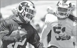  ?? Jayne Kamin-Oncea Getty Images ?? RAMS LINEBACKER Dakota Allen chases down running back John Kelly at practice. Allen had four tackles in the Rams’ preseason opener Saturday night.