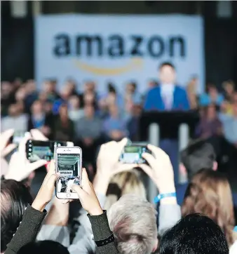  ?? JEFF VINNICK/GETTY IMAGES ?? Staff take photos as Prime Minister Justin Trudeau announces Amazon is set to create 3,000 jobs in Vancouver. Although Canada’s tech ecosystem is growing, it is seen as difficult to navigate.