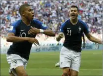  ?? DAVID VINCENT — THE ASSOCIATED PRESS ?? France’s Kylian Mbappe, left, celebrates with teammate Lucas Hernandez after scoring his side’s third goal during the match against Argentina in Kazan, Russia on Saturday.