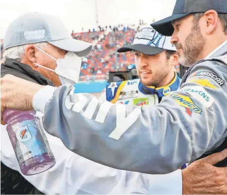  ?? HAROLD HINSON/HHP CHEVY RACING ?? Team owner Rick Hendrick, left, gets a hug from seven-time NASCAR champ Jimmie Johnson with Chase Elliott, who won the Cup title this year, looking on.