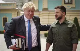  ?? UKRAINIAN PRESIDENTI­AL PRESS OFFICE VIA AP ?? Ukrainian President Volodymyr Zelenskyy, right, and Britain's Prime Minister Boris Johnson talk ahead of their meeting in Kyiv, Ukraine, on Friday.