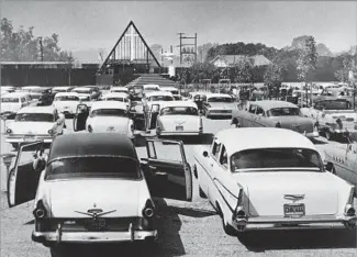  ??  ?? DRIVE-IN RELIGIOUS SERVICE As Schuller’s church had no place for worship, he rented a drive-in theater, here in 1957. Congregant­s often arrived in pajamas and listened to the service through speakers clipped to car windows.