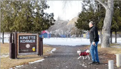  ?? NEWS PHOTO COLLIN GALLANT ?? Bill Homes and his dog Muffin walk past the entrance to the Kinette Kormer playground Monday afternoon in Kin Coulee Park. A modernizat­ion of the kitchen shelter there is one of several projects that fall under a community partnershi­p program between city hall and local groups.