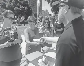  ?? SARAH HAUER/MILWAUKEE JOURNAL SENTINEL ?? Downtown workers receive free lunch in July 2019 from Pita Pit in Red Arrow Park as part of Downtown Employee Appreciati­on Week. The week runs Aug. 30 to Sept. 3 this year.