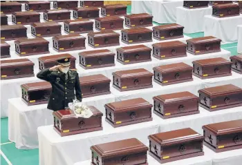  ?? JEON HEON-KYUN/GETTY-AFP ?? A Chinese military officer honors fallen soldiers from that country during coffin rites and a repatriati­on ceremony Wednesday in Incheon, South Korea. The remains are of Chinese soldiers killed in the 1950-1953 Korean War.