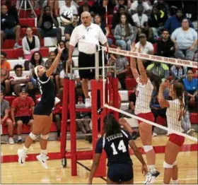  ?? THE MORNING JOURNAL FILE ?? Lorain’s Evelyn Williams taps the ball at the net against Elyria on Aug. 24.