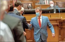  ?? AP-Alyssa Pointer ?? Georgia Gov. Brian Kemp is greeted as he visits the House Chambers on Sine Die, day 40, of the legislativ­e session in Atlanta on Friday.