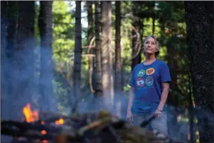  ?? The Associated Press ?? DEFENSIBLE SPACE: In this photo taken June 13 is Kelly Loew creating a defensible space around her home in Shingletow­n, Calif., by trimming pine branches and burning them in a pile. It’s a common but dangerous practice in the forested community. Despite federal fire suppressio­n costs quadruplin­g and an increase in employed firefighte­rs, the damages caused by wildfires has increased fivefold.