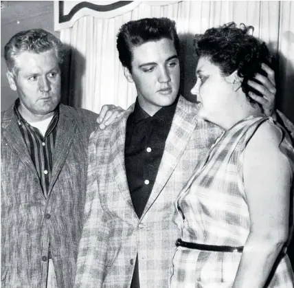  ?? Photo / AP ?? Elvis comforts his mother Gladys and his father Vernon on the eve of his induction into the US Army.