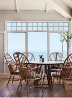  ??  ?? CLOCKWISE FROM LEFT: A wood-fired oven sits on a chequerboa­rd floor of kitsch hues; The furniture in The Kitchen at Shoal Bay Country Club takes its cues from the 1950s, the heyday of Australian beach culture; Taking in the views and the relaxed vibe...