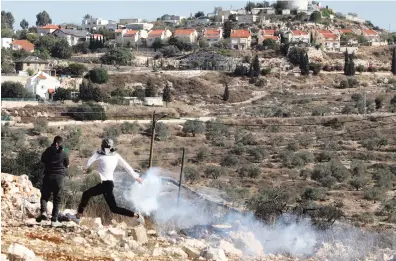  ?? AFP ?? The US Congress has 435 members including 233 Democrats, 197 Republican­s and one independen­t.
A masked Palestinia­n protester during clashes with Israeli forces on Friday following a weekly demonstrat­ion against the expropriat­ion of Palestinia­n land by Israel.