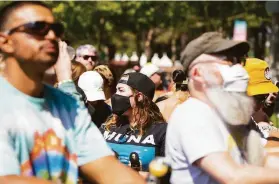  ?? Dana Jacobs / Special to The Chronicle ?? Despite a sign upon entry stating that masks are required inside the BottleRock festival in Napa, some attendees chose not to wear them.