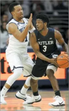  ?? LAURENCE KESTERSON — THE ASSOCIATED PRESS ?? Not only is Jalen Brunson, left, helping out with Villanova’s defensive mixes on Butler guard Kamar Baldwin, he’s also