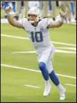  ?? Associated Press ?? FIRST TD PASS — Chargers quarterbac­k Justin Herbert celebrates after throwing his first career touchdown pass during the first half against the Chiefs on Sunday.