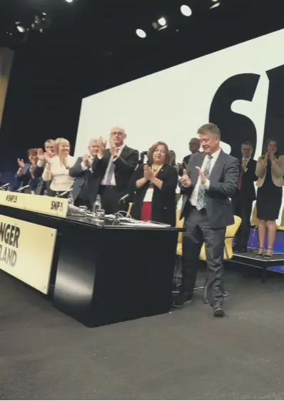  ??  ?? 0 First Minister Nicola Sturgeon waves to the crowd at the SNP conference in Edinburgh yesterday, with the party’s top team in attendence