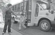  ?? WM. GLASHEEN/USA TODAY NETWORK-WISCONSIN ?? Corrine Hendrickso­n helps 4-year-old Aurora Funseth off the bus after her 4K class in New Glarus. Hendrickso­n’s program, Corrine’s Little Explorers, is a home-based family child care center.