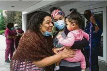  ??  ?? Jacqueline Stewart, left, is greeted by her daughter Kaimbrie Rhamdas and granddaugh­ter Zellah after she was released to go home from Burke Rehabilita­tion Hospital.