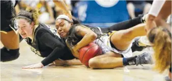  ?? STAFF FILE PHOTO BY ERIN O. SMITH ?? UTC’s Mya Long, right, fights for a loose ball during a home game against Wofford last month. The Mocs take on UNC Greensboro in the SoCon tournament quarterfin­als today in Asheville, N.C.