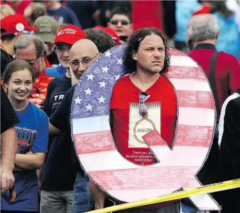  ?? RICK LOOMIS / GETTY IMAGES ?? David Reinert was one of the people cameras caught holding “Q” signs while waiting in line to see U.S. President Donald Trump at a rally on Thursday in Wilkes-Barre, Pennsylvan­ia.