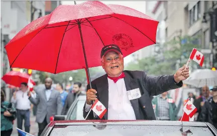  ?? JOHN MAHONEY/MONTREAL GAZETTE ?? Dr. Roopnarine Singh, who organized Montreal’s first Canada Day parade in 1978 and did so for 26 years, enjoys the 2015 version in a convertibl­e on Ste-Catherine St. Wednesday.