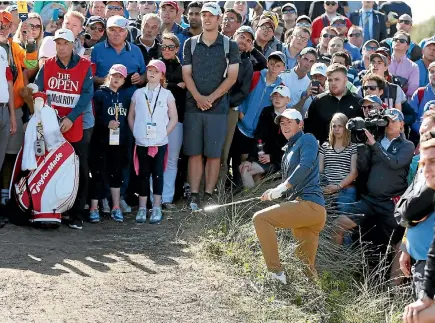  ?? PHOTO: REUTERS ?? Dozens of fans, and caddie JP Fitzgerald, left, get a close-up look at world No 4 Rory McIlroy as he plays from the rough on the eighth hole.