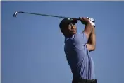  ?? DENIS POROY — THE ASSOCIATED PRESS ?? Tiger Woods hits his tee shot on the 15th hole of the North Course at Torrey Pines Golf Course during the first round of the Farmers Insurance Open on Thursday in San Diego.