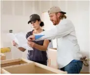  ?? MAGNOLIA VIA THE NEW YORK TIMES ?? Chip and Joanna Gaines discuss cabinets while working on a home. The Gaineses’ home design work seems to divide along traditiona­l gender lines, but Joanna is the driving force behind the brand.