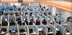  ?? AP Photo/Alex Cossio, File ?? Long hours: Workers sit at desks at a call center in the northern border city of Tijuana, Mexico. If you spend all day sitting, then you might want to schedule some time for a brisk walk - just make sure you can spare at least an hour. Scientists...