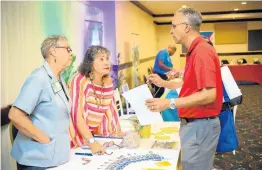  ??  ?? Juliet Gordon of Olde Jamaica Tours (left) and community tourism expert Diana McIntryre Pike of My Jamaica Travel (centre) providing informatio­n to a visitor to their booth.