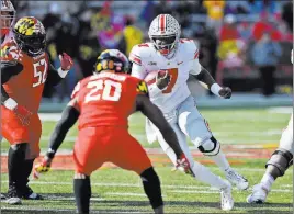 ?? Nick Wass The Associated Press file ?? Ohio State quarterbac­k Dwayne Haskins Jr. (7) runs with the ball against Maryland defensive back Antwaine Richardson (20) and defensive lineman Oluwaseun Oluwatimi (52) during their Nov. 17 game in College Park, Md. Ohio State coach Urban Meyer says Haskins became a legitimate leader in that game.